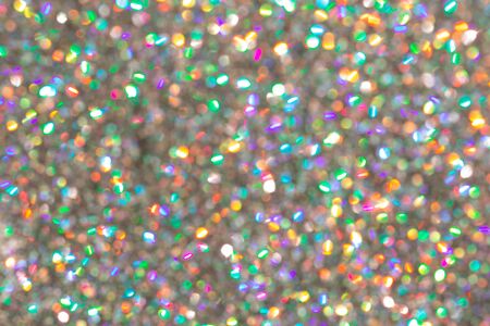 Blurred background with holographic sparkles and lights.の写真素材