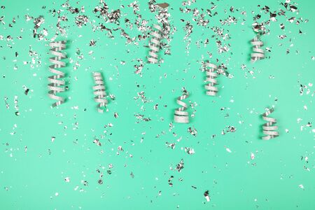 Silver flying sparkles on blue holiday background. Festive backdrop for your projects.の写真素材