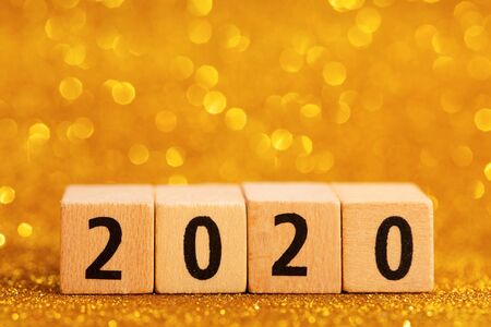 Horisontal numbers of 2020 on golden sparkling background. Place for text. Festive concept.の写真素材