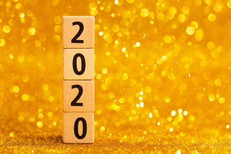 Horisontal numbers of 2020 on golden sparkling background. Place for text. Festive concept.の写真素材