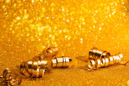Golden festive swirl on sparkling background with place for text. Christmas concept.の写真素材