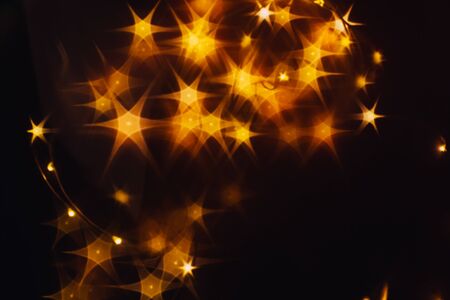 Splash of golden stars on black background.の写真素材