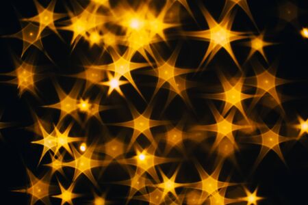 Splash of golden stars on black background.の写真素材