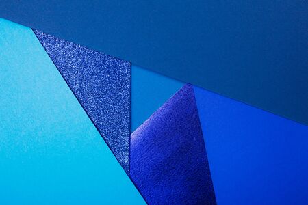 Divided in several parts blue paper background with metallic elemments. Inspired by color of the year 2020の写真素材