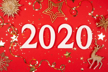2020 on red background with sparkles. Flat lay style.の写真素材