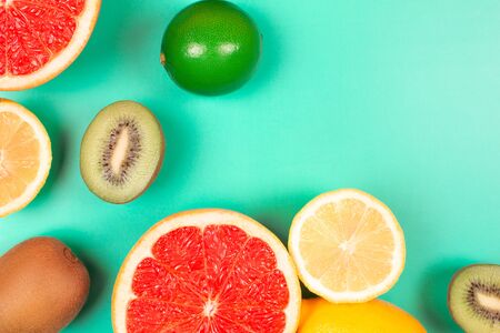 Fruits on trendy green background. Flat lay style.の写真素材