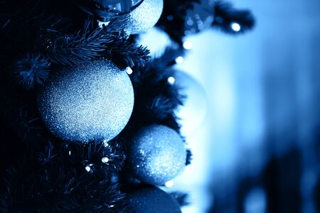Fir branch with balls and festive lights on the Christmas background with sparkles.の写真素材