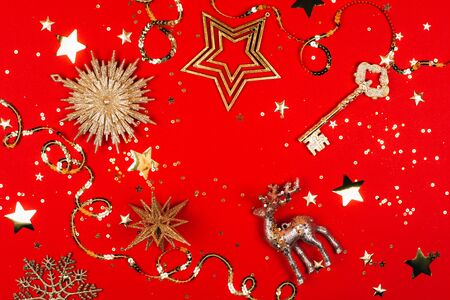 Golden christmas toys on red background. Flat lay style.の写真素材