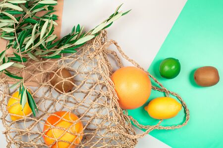 Fruits on textile bag. Trendy green background. Zero waste concept. Flat lay style.の写真素材