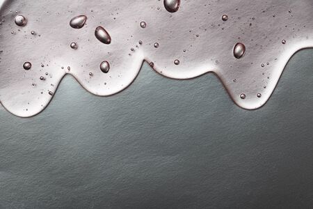 Hyaluronic acid gel. Textured background with oxygen bubbles on silver background.の写真素材