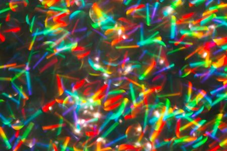 Blurred background with holographic sparkles and lights.