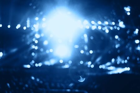 Blurred people crowd at musical concert and stage lights. Defocused background.の写真素材