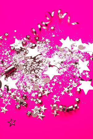 Silver sparkles on pink background. Holiday concept.の写真素材