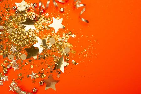 Golden sparkles on coral background. Holiday concept.の写真素材
