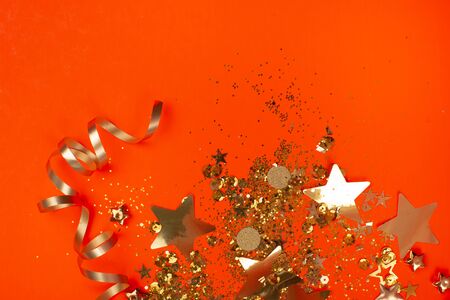 Golden sparkles on coral background. Holiday concept.の写真素材