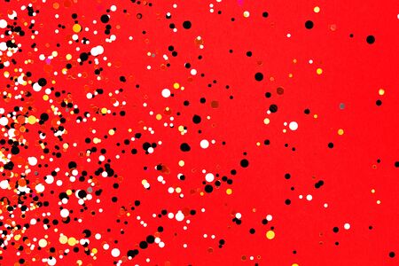 Falling confetti on red background. Holiday and party concept.の写真素材