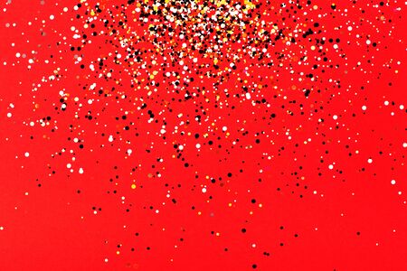Falling confetti on red background. Holiday and party concept.の写真素材
