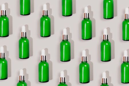 Pattern made with green care cosmetics bottle. Flat lay style.の写真素材