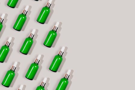 Pattern made with green care cosmetics bottle. Flat lay style.の写真素材