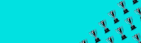 Banner with Pattern made with champion cup and copy space on blue background, Flat lay style. Open composition.の写真素材