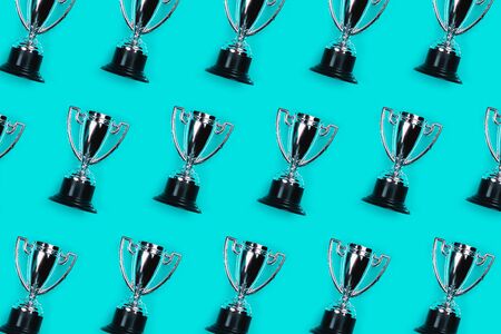 Pattern made with champion cup on blue background, Flat lay style. Open composition.の写真素材