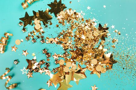 Golden sparkles on blue background. Holiday concept.の写真素材