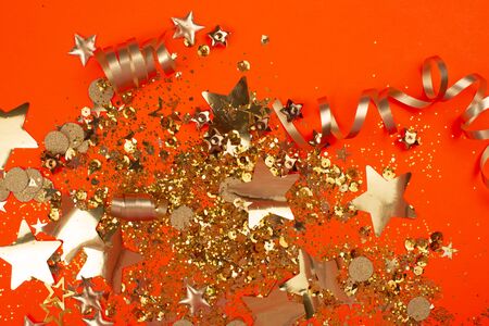 Golden sparkles on coral background. Holiday concept.の写真素材