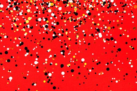 Falling confetti on red background. Holiday and party concept.の写真素材