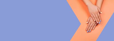 Manicure in trendy colors: coral, rose gold and blue on colorful background. Flat lay style. Perfect web banner.の写真素材