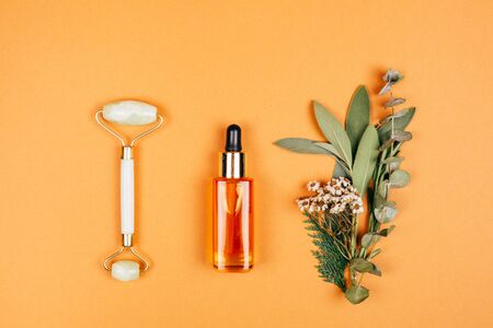 Modern apothecary with natural ingredients. Oil made of herbs herbs. Face roller for self-care. Flat...