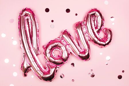 Love foil balloon on monochrome colorful backdrop. Valentines day concept.の写真素材