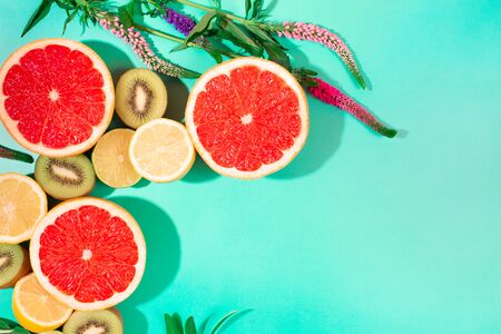 Fruits on trendy green background. Flat lay style.の写真素材