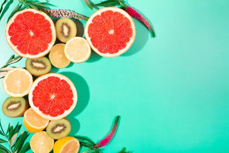 Fruits on trendy green background. Flat lay style.の写真素材
