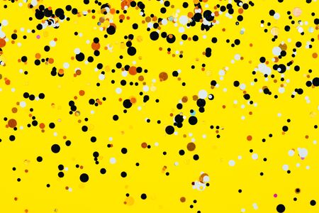 Falling confetti on yellow background. Holiday and party concept.の写真素材