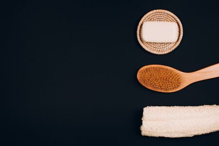 Skin care zero waste products on black background. Washcloth, skin brush and soapの写真素材