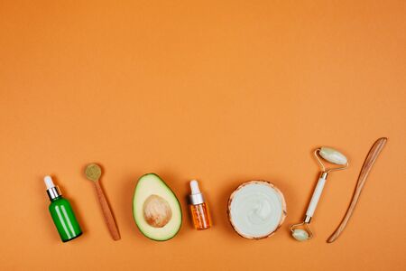 Natural face care cosmetics with ingredients on peach background. Flat lay style.の写真素材