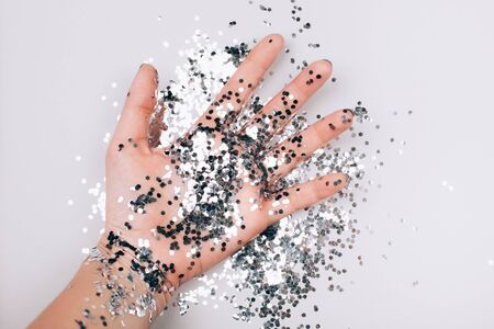 Womans hand with silver sparkles. Flat lay styleの写真素材