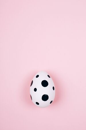 Easter egg on trendy pink pastel background. Flat lay style.の写真素材