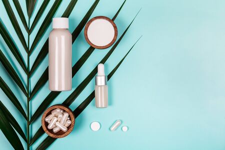Different types of collagen on palm leaf. Powder, capsules, tablets and fluid.の写真素材