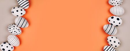 Banner made with Easter eggs dotted on multicolored background. Festive concept. Flat lay styleの写真素材
