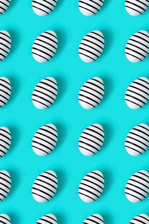 Pattern made of hand drawn eggs on blue pastel background. Easter concept.の写真素材