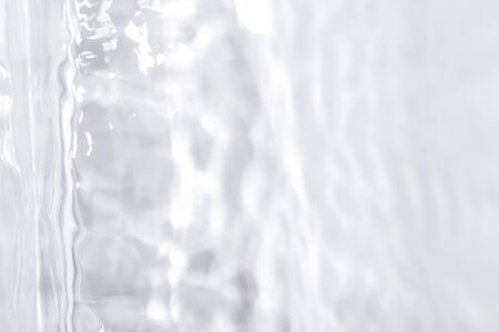 Shadows made with water. Blurred background made with water and light in monochrome. Pureness concept.の写真素材