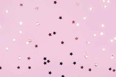 Rose gold stars on a pink background. Festive concept. Flat lay styleの写真素材