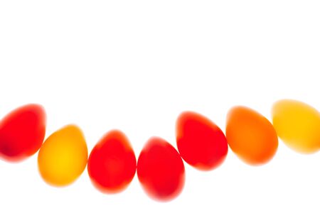 Multicolored eggs in a row on white background. Easter concept. Flat lay style.の写真素材