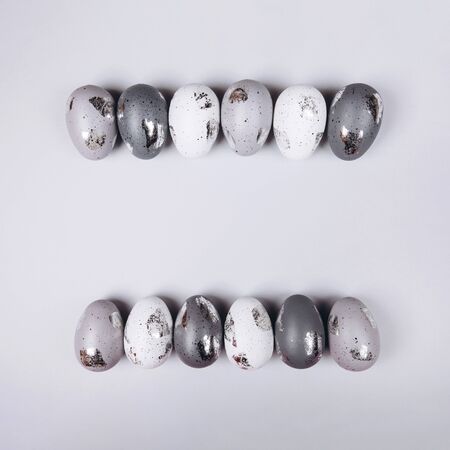 Easter eggs in two rows on grey background. copy space.の写真素材