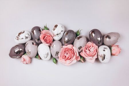 Group of Easter eggs and flowers on grey background. copy space.の写真素材