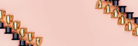 Winner cups on a pink background. Banner with a place for text. Flat lay style.の写真素材