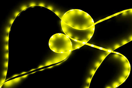 Abstract background of yellow neon led lights on black. Backdrop for your design.の写真素材