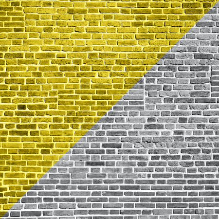 Demonstrating trendy colors 2021 - Gray and Yellow. Beautiful accurate textured brick wall on a bright sunny day. Brick backgroundの写真素材