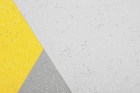 Paper background with metallic shiny stars and glitter in two trendy colors - yellow and gray....